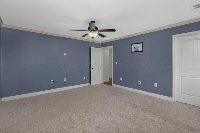 unfurnished bedroom featuring carpet, visible vents, baseboards, and ornamental molding