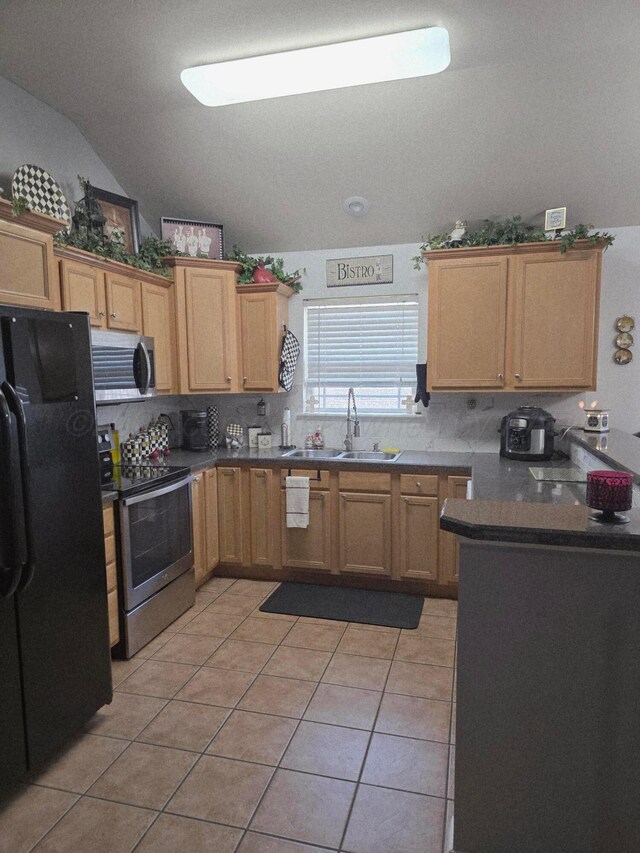4808 Mammoth Ln, Amarillo, TX 79110 - kitchen featuring stainless steel appliances, tasteful backsplash, light tile patterned floors, vaulted ceiling, and dark countertops