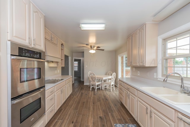 5519 Alvarado Rd, Amarillo, TX 79106 - kitchen with double oven, ceiling fan, light countertops, dark wood-style floors, and black electric stovetop