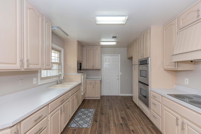 5519 Alvarado Rd, Amarillo, TX 79106 - kitchen with black appliances, dark wood-style flooring, light countertops, and custom exhaust hood