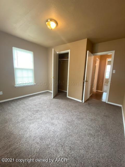 303 S Louisiana St, Amarillo, TX 79106 - unfurnished bedroom featuring carpet floors and a closet
