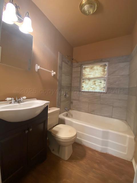 303 S Louisiana St, Amarillo, TX 79106 - bathroom with wood finished floors, vanity, and bathtub / shower combination