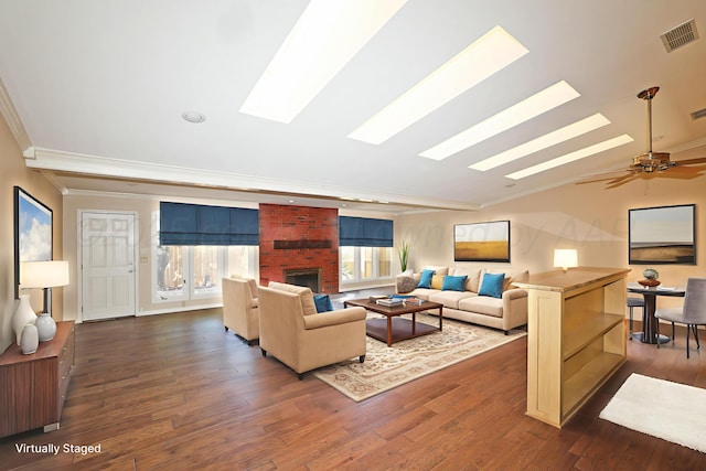 3449 Irving Ln, Amarillo, TX 79121 - living room featuring a skylight, ornamental molding, dark wood-type flooring, a fireplace, and lofted ceiling
