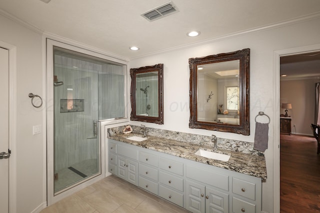 3449 Irving Ln, Amarillo, TX 79121 - bathroom featuring double vanity, a stall shower, crown molding, and recessed lighting