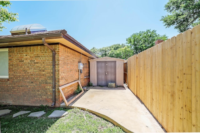 3449 Irving Ln, Amarillo, TX 79121 - view of home's exterior featuring brick siding, a shed, and a patio area