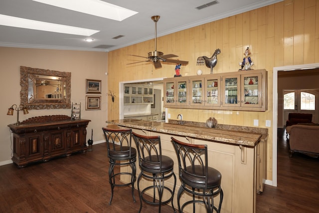 3449 Irving Ln, Amarillo, TX 79121 - indoor wet bar with ornamental molding, dark wood-type flooring, and wood walls