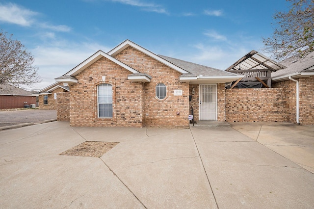 6011 Belpree Rd, Amarillo, TX 79106 - view of front of property featuring brick siding, a patio area, and a shingled roof