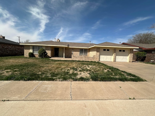 view of front of property with driveway, an attached garage, a front lawn, and brick siding