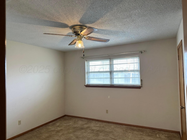 carpeted empty room with a textured ceiling, baseboards, and ceiling fan