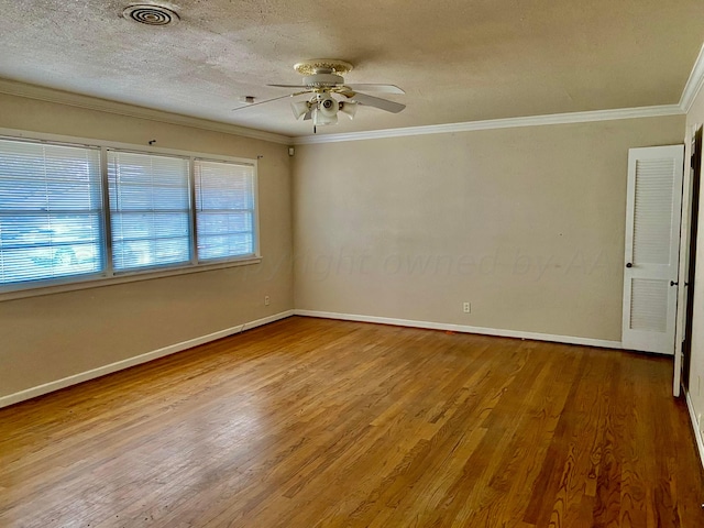 spare room featuring ornamental molding, a textured ceiling, wood-type flooring, and ceiling fan