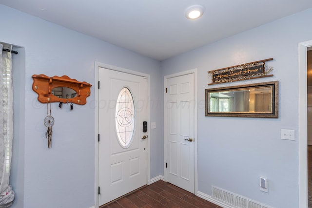 entryway with baseboards, dark wood-style flooring, and visible vents