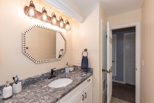 bathroom featuring tile patterned flooring, vanity, and visible vents