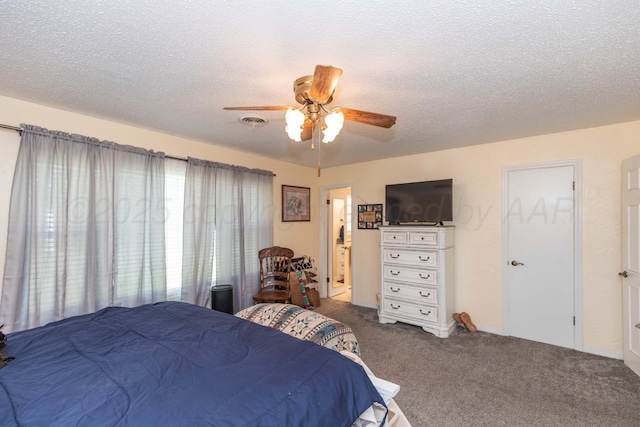 bedroom featuring a textured ceiling, carpet, visible vents, and a ceiling fan
