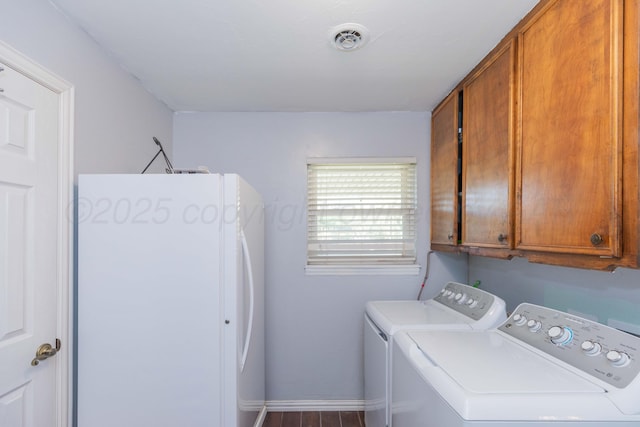 laundry room featuring wood finished floors, visible vents, baseboards, washer and dryer, and cabinet space