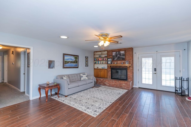 living area with dark wood finished floors, ceiling fan, baseboards, and french doors