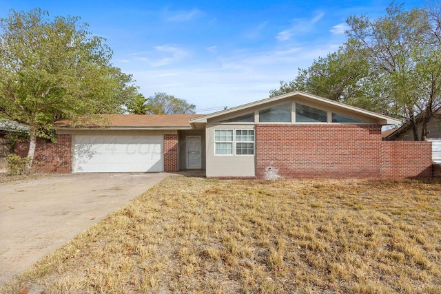 ranch-style home with a garage and a front yard