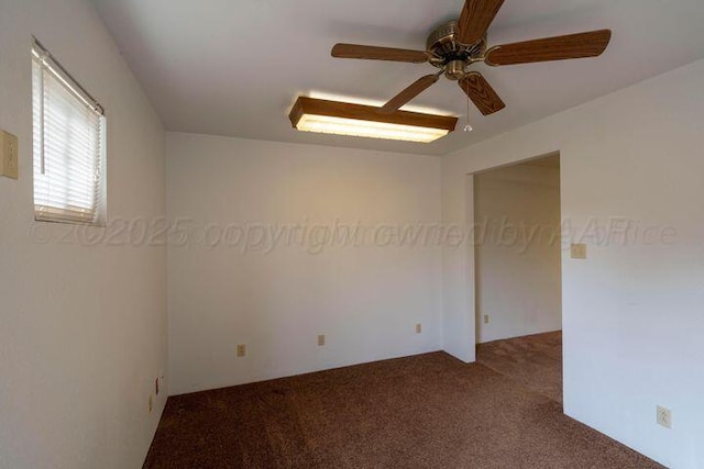 empty room with carpet floors and a ceiling fan