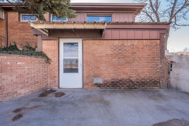 property entrance featuring brick siding