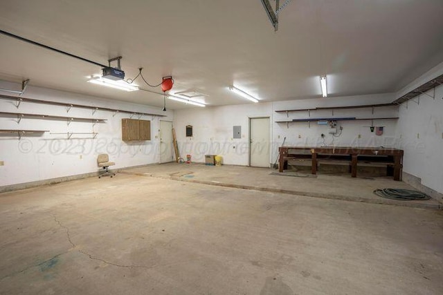 garage featuring a garage door opener and a workshop area