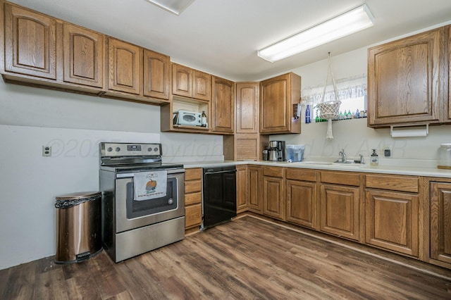 kitchen featuring brown cabinetry, dishwasher, electric range, and dark wood-style floors