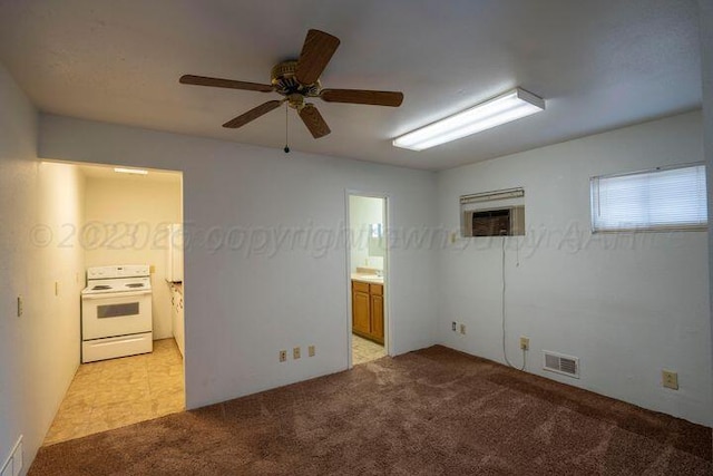 empty room featuring light carpet, visible vents, and a ceiling fan