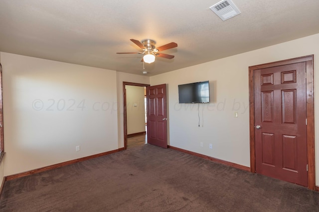 carpeted empty room featuring a textured ceiling and ceiling fan