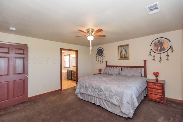 bedroom featuring ensuite bath, ceiling fan, and dark carpet