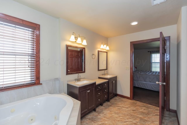 bathroom with a tub to relax in and vanity