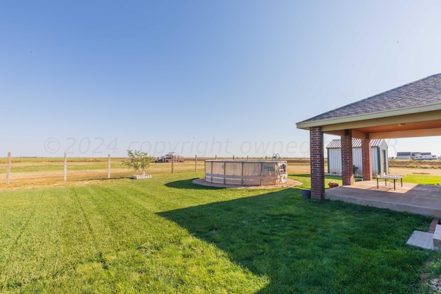 view of yard featuring a patio area and a rural view