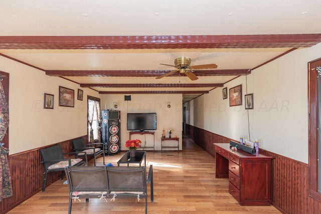 living room with light hardwood / wood-style flooring, wood walls, beamed ceiling, and ceiling fan