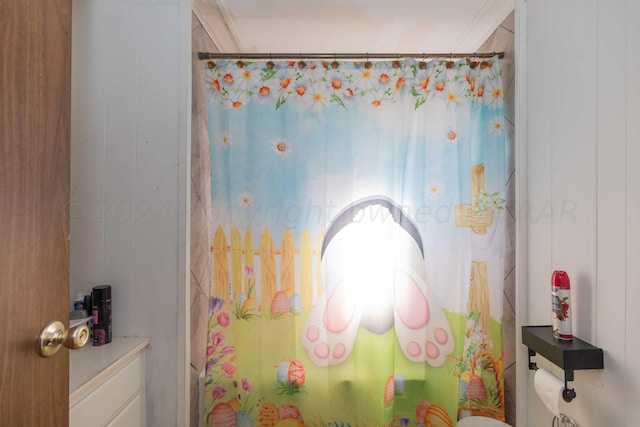 bathroom with shower / tub combo, wooden walls, and crown molding