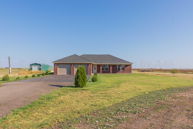 ranch-style house with a garage and a front yard