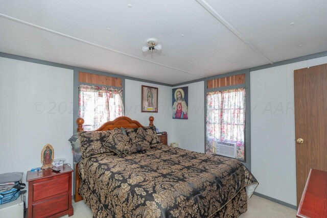 carpeted bedroom featuring multiple windows and cooling unit