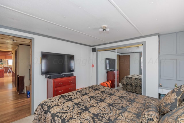 bedroom with a closet and light hardwood / wood-style flooring