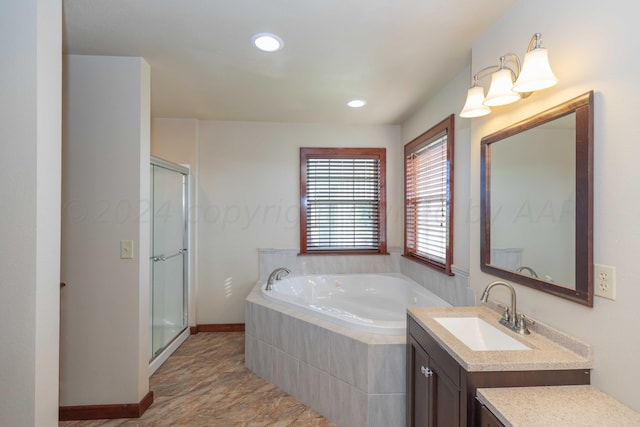 bathroom featuring vanity and shower with separate bathtub