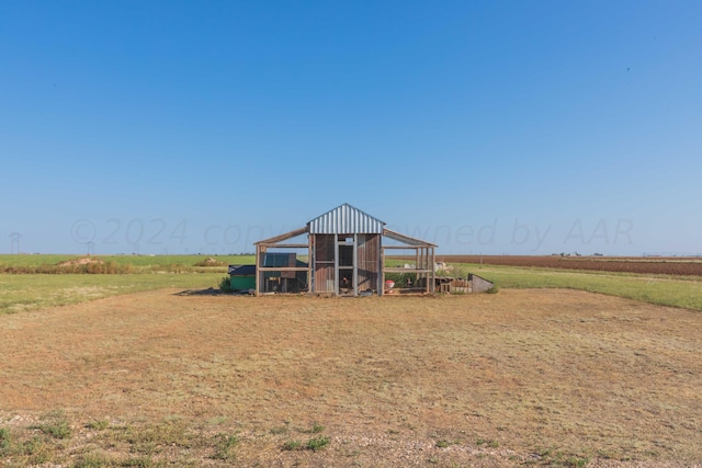 exterior space featuring an outdoor structure and a rural view