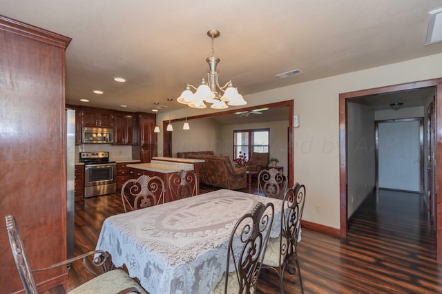 dining area with a chandelier and dark hardwood / wood-style floors