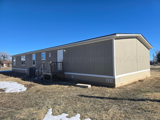 view of side of home featuring central AC unit