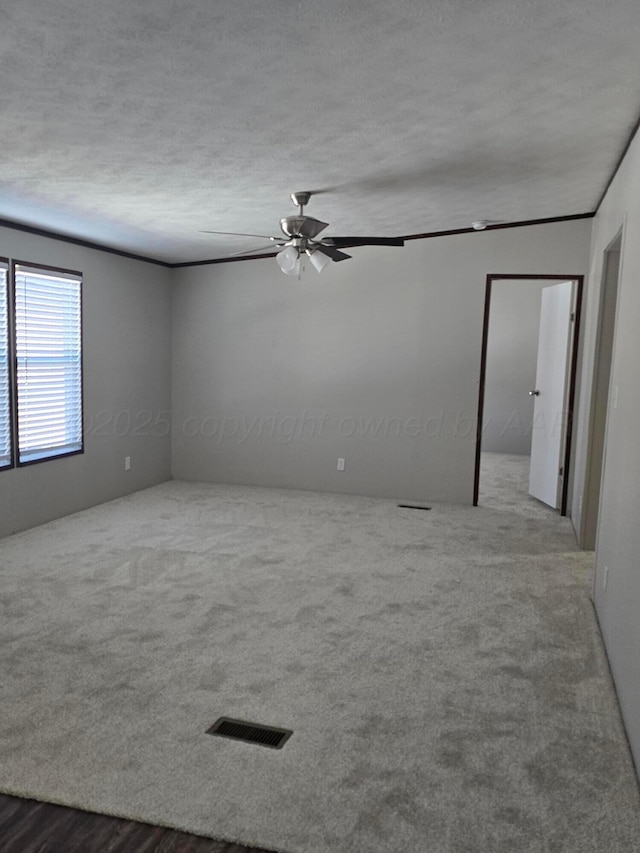 spare room with ceiling fan and a textured ceiling