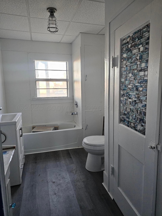 bathroom featuring hardwood / wood-style floors, vanity, a bathing tub, and a paneled ceiling