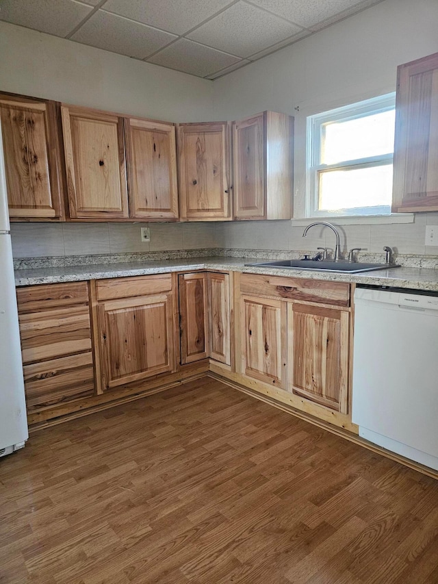 kitchen featuring dishwasher, dark hardwood / wood-style floors, and decorative backsplash