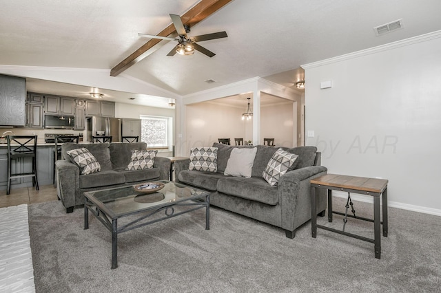 living room with vaulted ceiling with beams, ceiling fan with notable chandelier, crown molding, and carpet flooring