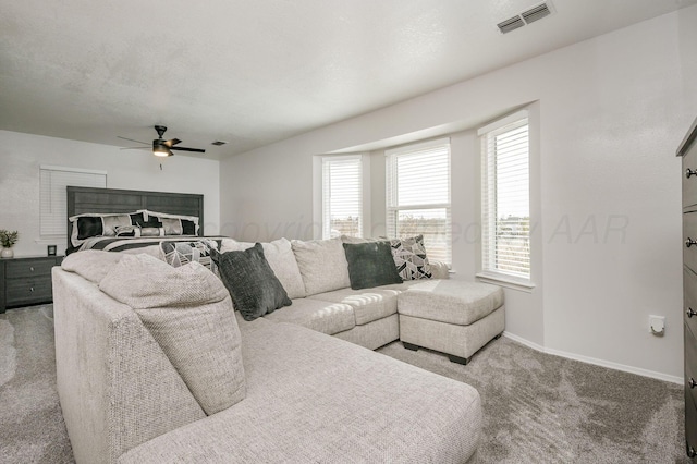 living room with ceiling fan and carpet floors