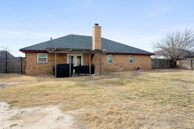 rear view of property featuring a yard