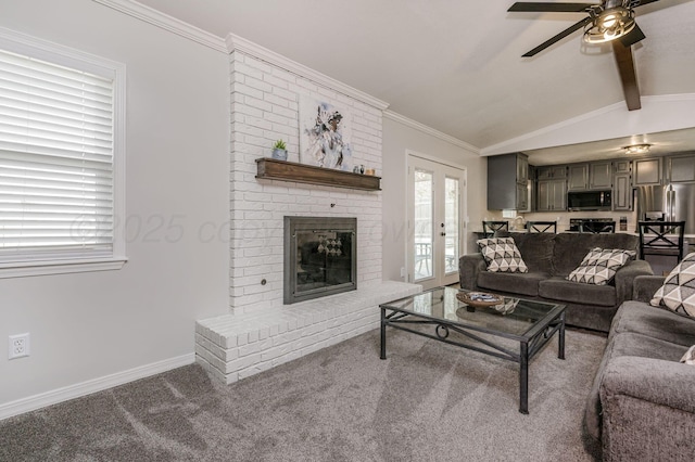 carpeted living room featuring french doors, a brick fireplace, ornamental molding, ceiling fan, and vaulted ceiling with beams