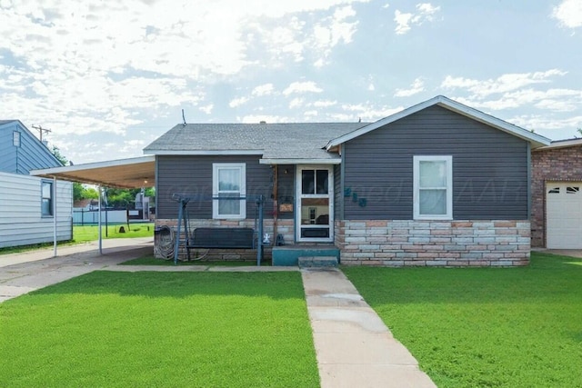 210 Oak Ave, Dumas, TX 79029 - ranch-style house featuring a front yard, driveway, stone siding, and a carport