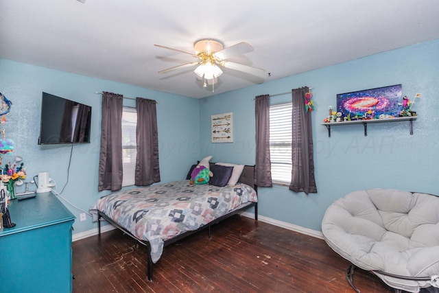 210 Oak Ave, Dumas, TX 79029 - bedroom with wood-type flooring and ceiling fan