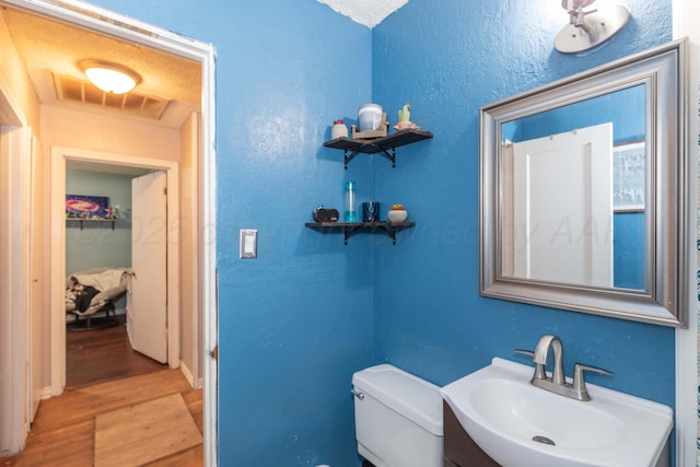 210 Oak Ave, Dumas, TX 79029 - half bath featuring wood finished floors and vanity