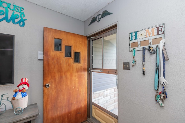 210 Oak Ave, Dumas, TX 79029 - doorway with a textured wall and a textured ceiling