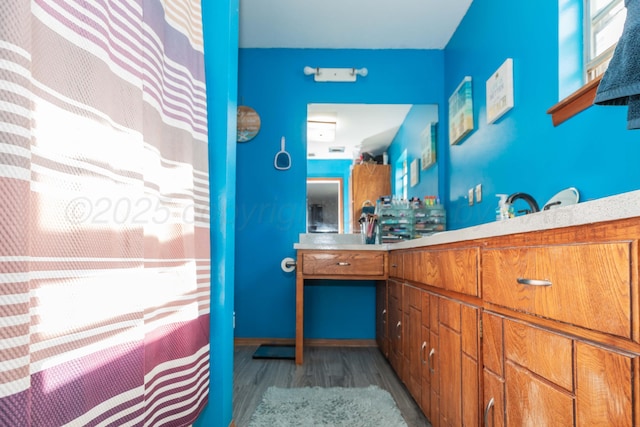 210 Oak Ave, Dumas, TX 79029 - full bathroom featuring wood finished floors and vanity